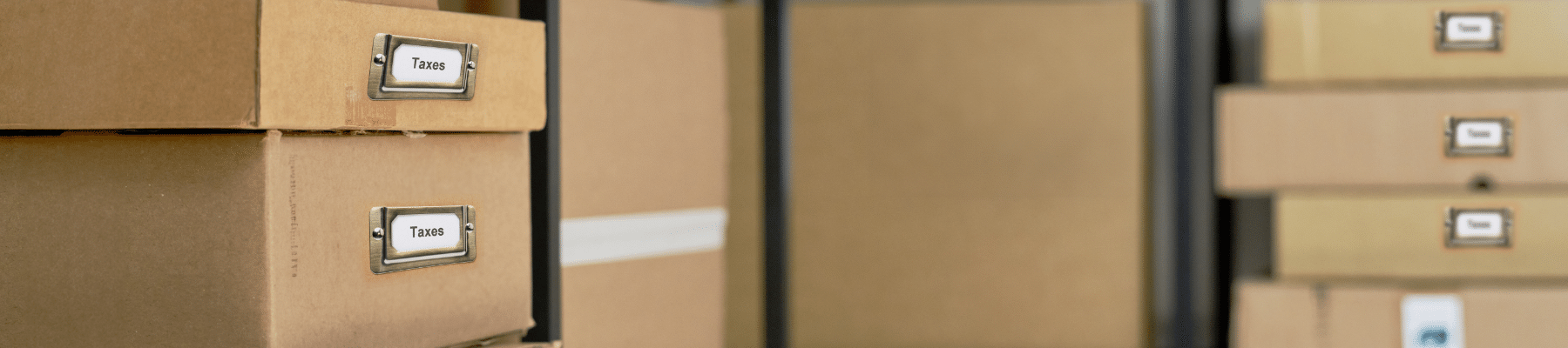 Image of boxes stacked in a storage unit, labeled as Tax Documents