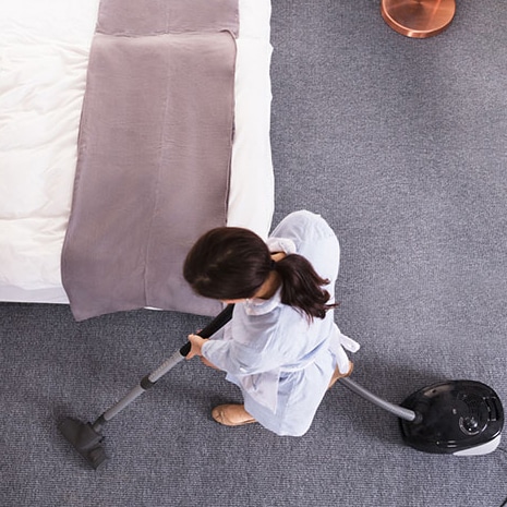 A person vacuuming from above